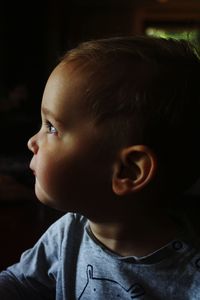 Close-up of cute baby boy looking away