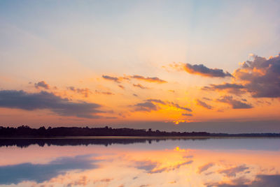 Sunset reflection lagoon. beautiful sunset behind the clouds and blue sky above the over lagoon