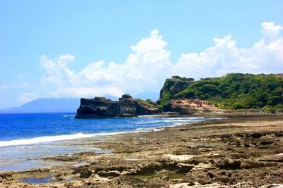 Scenic view of sea against cloudy sky
