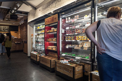 Rear view of man standing at store