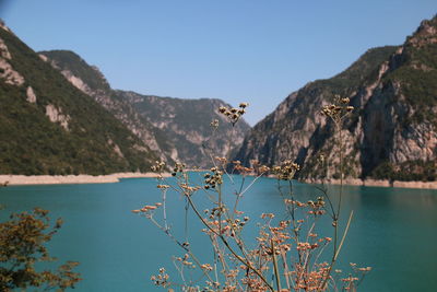 Scenic view of lake and mountains against clear sky