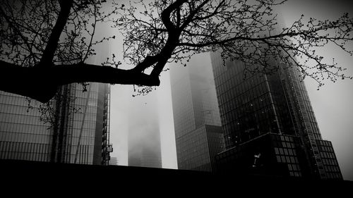 Low angle view of silhouette buildings against sky