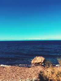 Scenic view of sea against clear blue sky