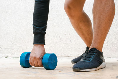 Low section of man standing on exercise mat