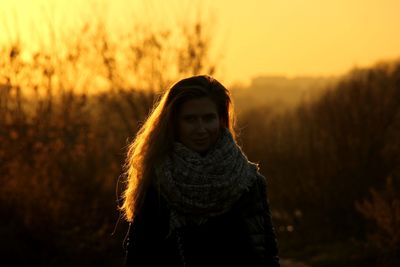 Woman standing on land during sunset