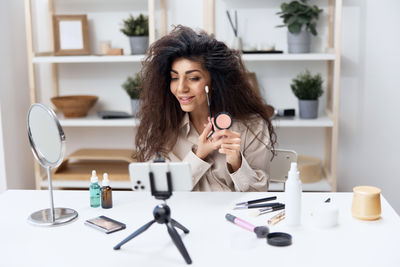 Portrait of young woman working at home