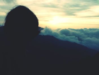 Rear view of silhouette woman against sky