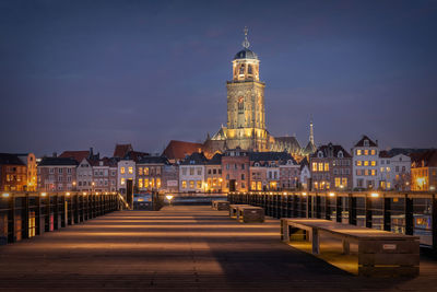 Illuminated buildings against sky at night