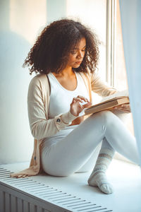 Young woman sitting on table