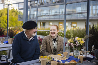 Neighbors having outdoor meal in courtyard