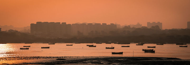 Scenic view of buildings against sky during sunset