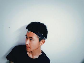 Close-up of a young man over white background