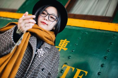 Close-up of young woman standing by train