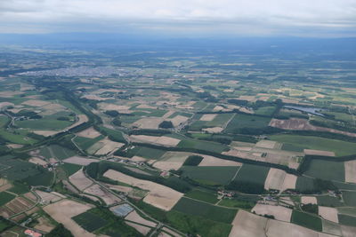 Aerial view of agricultural landscape against sky