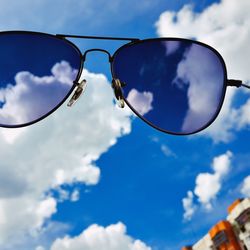 Low angle view of sunglasses against sky
