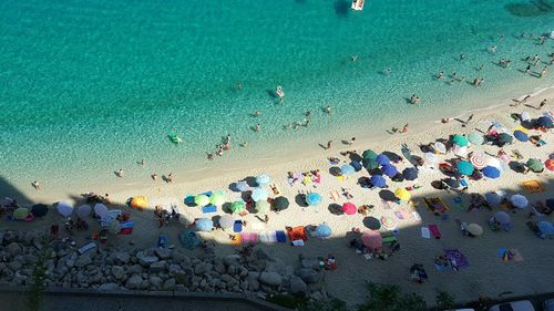 High angle view of people enjoying at beach