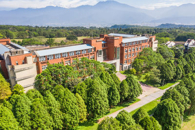 High angle view of trees and buildings against mountains