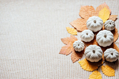 Autumn creative craft background web banner with decorative clay pumpkins and wooden autumn leaves