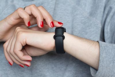 Midsection of woman wearing smart watch