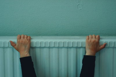 Cropped hands of person on wall 