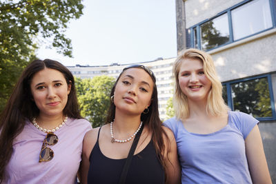 Portrait of young female friends spending time together outdoors