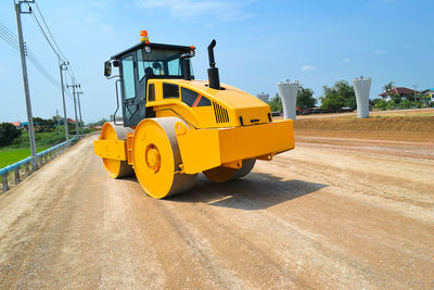 Yellow flag on road against sky