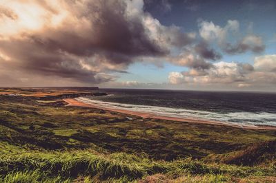 Scenic view of sea against cloudy sky