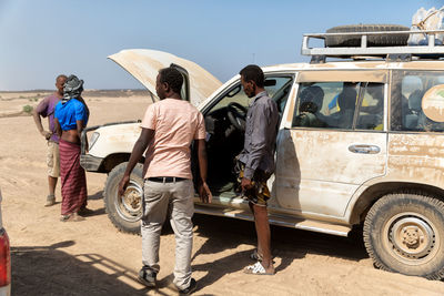 Rear view of people walking on road