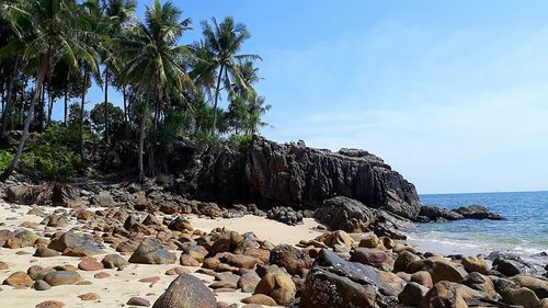 Rocks on beach against sky