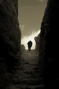 Rear view of woman standing on cliff