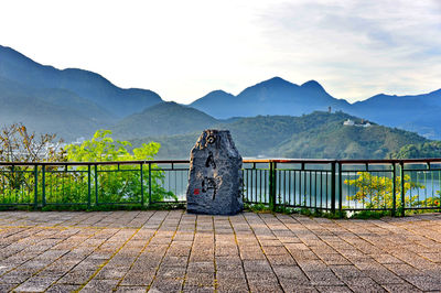 Stone structure on mountain against cloudy sky