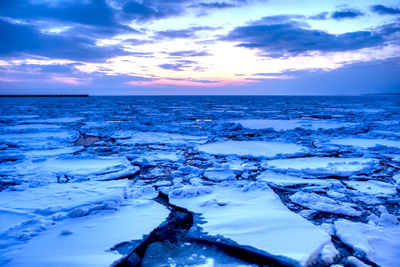 Scenic view of sea against sky during winter