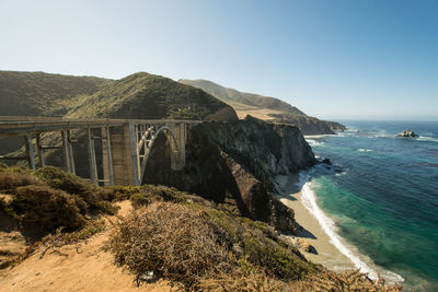 Scenic view of bixby creek bridge by sea against sky at big sur