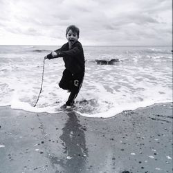 Boy standing on shore at beach