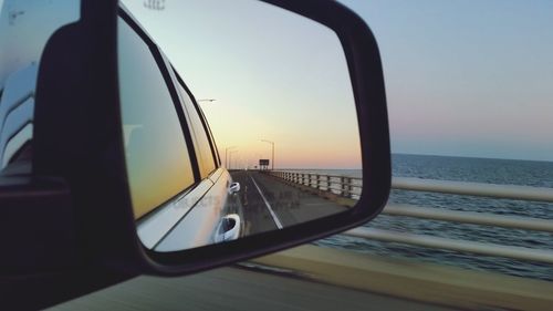 Reflection of sky in side-view mirror