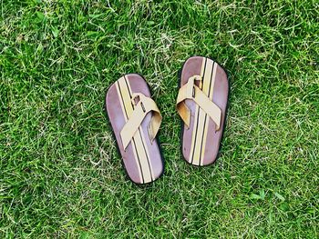 High angle view of shoes on grassy field