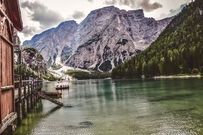 Scenic view of lake by mountains against sky