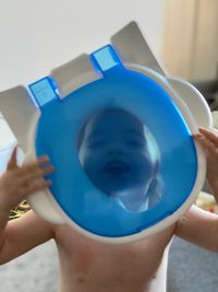 Close-up of boy holding blue eyes