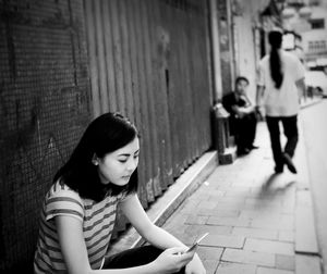 Young woman sitting outdoors