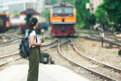 Full length of woman standing at railroad station