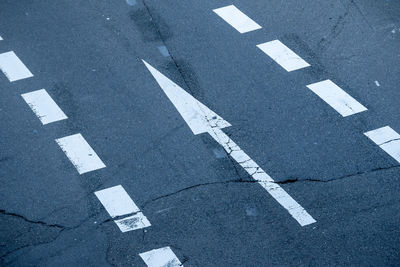 High angle view of arrow sign on road in city