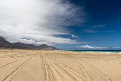 Scenic view of beach against blue sky