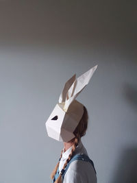 Woman wearing paper rabbit mask