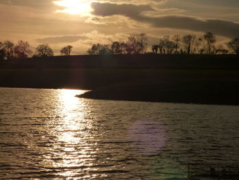 Scenic view of lake against sky during sunset