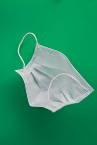 Close-up of umbrella against green background