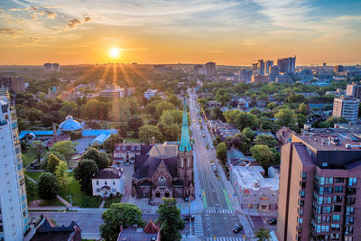 High angle view of city buildings against sky during sunset