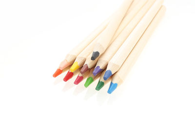 Close-up of multi colored pencils on white background