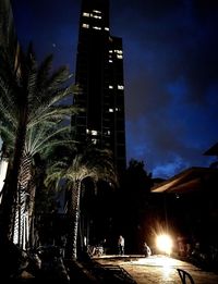 Low angle view of modern building against sky at dusk