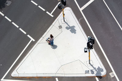 High angle view of man walking on the road