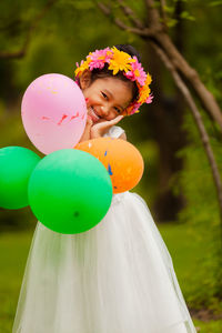 Cute girl holding balloons